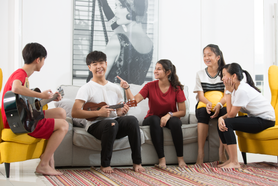 group of students playing guitar and having fun